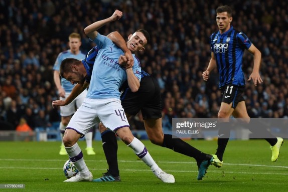 Manchester City's English midfielder Phil Foden (R) tangles with Atalanta's Albanian defender Berat Djimsiti (L) in the penalty area during the UEFA Champions League Group C football match between Manchester City and Atalanta at the Etihad Stadium in Manchester, northwest England on October 22, 2019. (Photo by Paul ELLIS / AFP) (Photo by PAUL ELLIS/AFP via Getty Images)